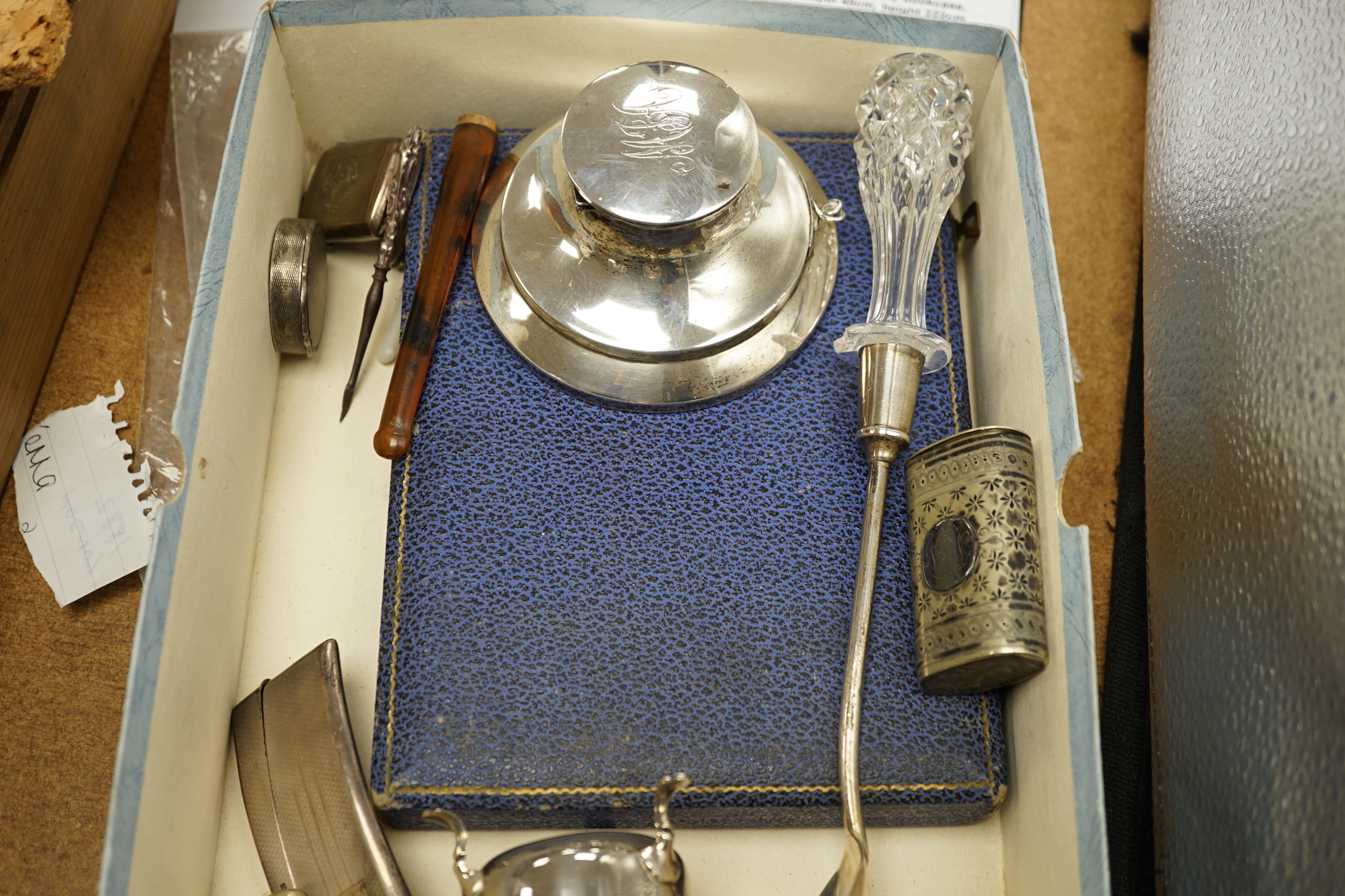 A quantity of assorted silver and sterling items including cigarette case, card case, vesta cases, mounted inkwell, glass handled salad server, plated vesta case, etc.